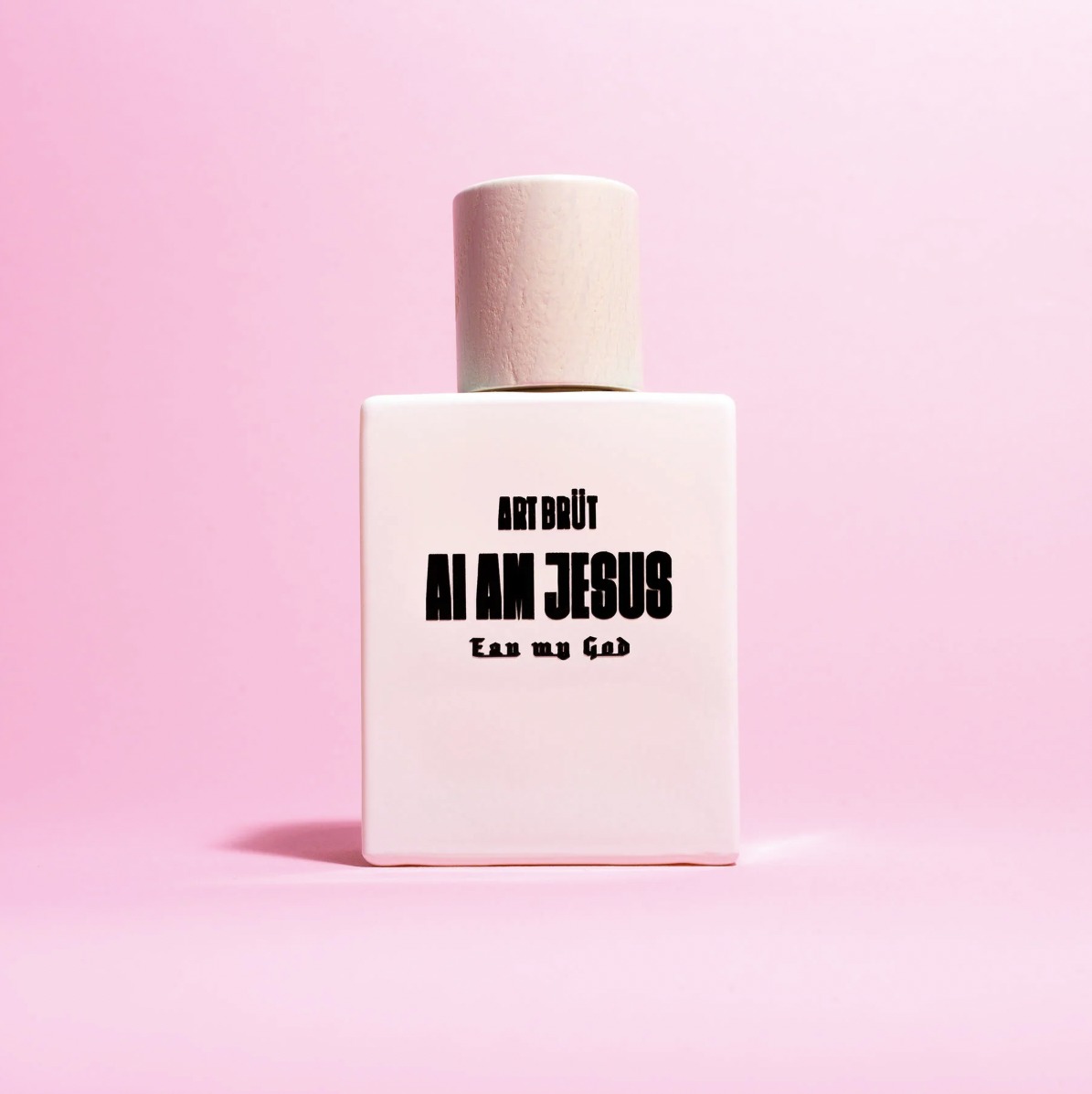 White AI AM JESUS – Eau my God perfume bottle by ART BRÜT on a pink background